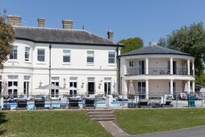 a large white house with a pool in front of it at Quayside in Christchurch