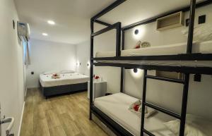 a room with three bunk beds and a bed at Casa Gladius in Jericoacoara