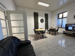 a living room with tables and chairs and a couch at Central Apartments Hof in Hof