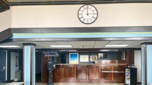 a clock on the wall of a waiting room at Studio 6 Suites Fremont, OH in Fremont
