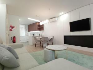 a white living room with a couch and a table at Da Valeta Ó in Arcos de Valdevez +8 photos