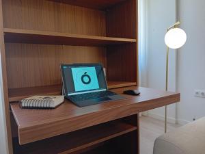 a laptop computer sitting on top of a wooden desk at Da Valeta Ó in Arcos de Valdevez