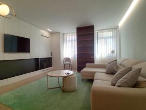 a living room with a couch and a flat screen tv at Da Valeta Ó in Arcos de Valdevez