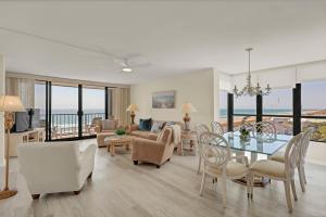 a dining room and living room with a view of the ocean at Station One - 6K by Sea Scape Properties in Wrightsville Beach