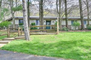 a house with a fence in front of a yard at Mountain Maryland Adventures Await in McHenry