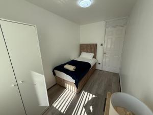 a small bedroom with a bed and a closet at The cumbria place in Elswick