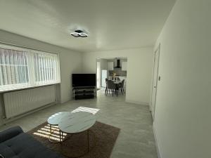 a living room with a couch and a table at The cumbria place in Elswick