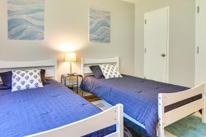 two beds in a bedroom with blue bedding at Mountain Maryland Adventures Await in McHenry
