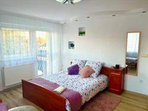 a bedroom with a bed with a dresser and a mirror at Zaciszny domek in Słupsk