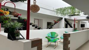 a room with chairs and plants and stairs at Operadora Stay - Edificio Puerto Living in Barrancabermeja