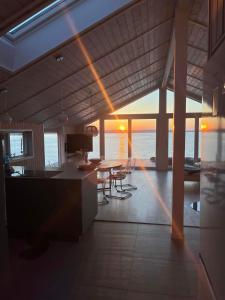 a kitchen and dining room with a view of the ocean at Udsigten over Hjarbæk in Løgstrup