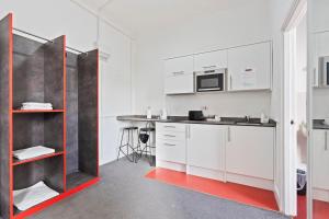 a kitchen with white cabinets and a counter top at Modern Self-Contained Studio in Dudley Sleeps 2 in Dudley
