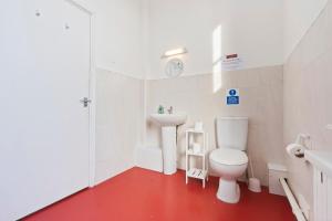 a white bathroom with a toilet and a sink at Modern Self-Contained Studio in Dudley Sleeps 2 in Dudley
