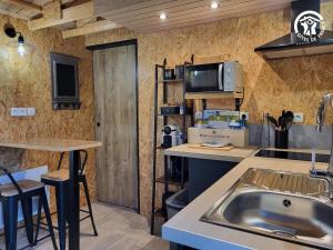 a kitchen with a sink and a counter top at La cachette du G in Bellebrune +21 photos