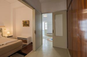 a bedroom with a bed and a door to a hallway at Bougainvillea House in Parikia +117 photos