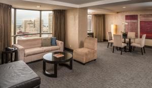 a living room with a couch and a table at Hilton Parc 55 San Francisco Union Square in San Francisco