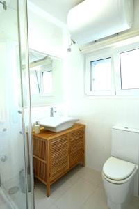 a bathroom with a sink and a toilet at Adriatic Breeze in Hvar +33 photos