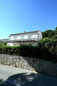a house with a stone wall and a building at Adriatic Breeze in Hvar