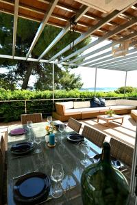 a table with wine glasses and a bottle on a patio at Adriatic Breeze in Hvar