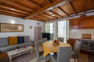a living room with a table and a couch at Bougainvillea House in Parikia