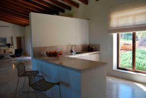 a kitchen with a counter and chairs in a room at Luxury Villa Son Mas in Manacor