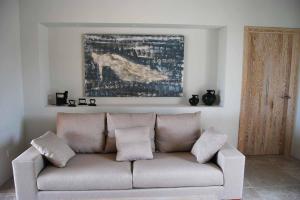 a couch in a living room with a painting on the wall at Luxury Villa Son Mas in Manacor