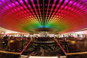 a large room with a colorful ceiling in a restaurant at The Cumberland, London in London