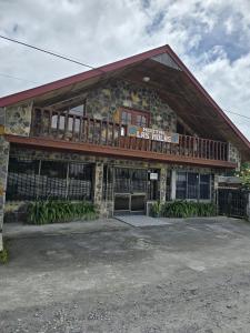 a building with a deck on top of it at Hostal Las Molas in Volcán