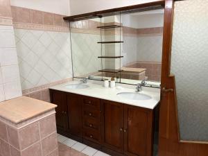 a bathroom with two sinks and a mirror at Casa D'Agostino in Cortona