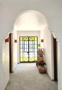 a hallway with a door with a window at Hospedarte Central Hotel in Guadalajara