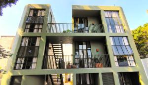 an apartment building with balconies and windows at Hospedarte Central Hotel in Guadalajara