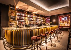 a bar with stools in a room at The Cumberland, London in London