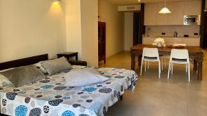 a bedroom with a bed and a table and chairs at Appartamento Zu fronte lago con piscina in Fonteno +39 photos