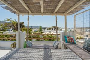 a porch with chairs and a view of the ocean at Bougainvillea House in Parikia
