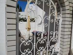 an open gate with an umbrella on a patio at Apartments Kavan in Barbariga