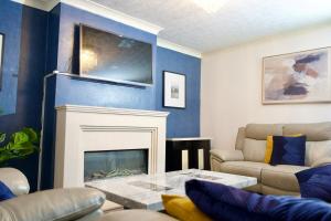 a living room with blue walls and a fireplace at The Bank in West Derby