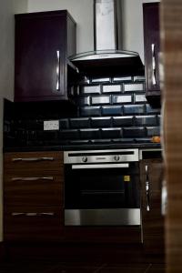 a kitchen with a stove and a stove top oven at The Bank in West Derby