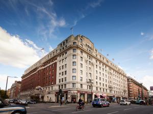 a large white building on a busy city street at The Cumberland, London in London