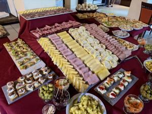 a table with many different types of food on it at San Miguel Plaza Hotel All Inclusive in Villa San Miguel