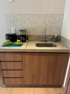a kitchen with a sink and a counter top at Cond VISTA AZUL in Pedra Azul