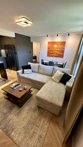 a living room with a couch and a table at Oliwa luxury apartment, free parking, high speed internet in Gdańsk