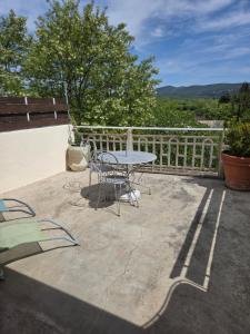 a table and chairs sitting on a patio at Hotel Des Sites in Salavas