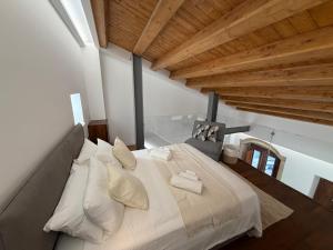 a bedroom with a large bed in a room with wooden ceilings at Donna Dina in Avola