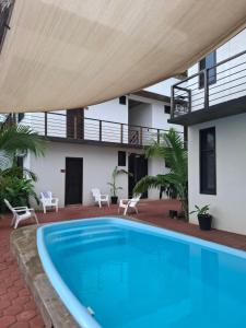 a swimming pool in front of a house at Casa Xolococo in Brisas de Zicatela