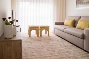 a living room with a couch and a table at Simon Guest Apartments in Porto