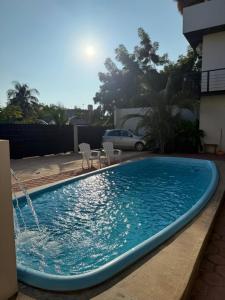 a swimming pool with a fountain in a yard at Casa Xolococo in Brisas de Zicatela +26 photos