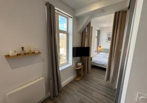 a bedroom with a bed and a window at Studio cosy Amiens in Amiens