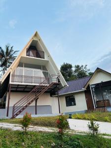a house with a gambrel roof at Wilmora in Ramakkalmedu +16 photos