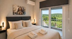 a bedroom with a large bed with a large window at Sountou home in Xanthi