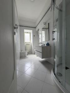 a bathroom with a shower and a sink and a toilet at Naturalis Historia Meta in Meta +58 photos